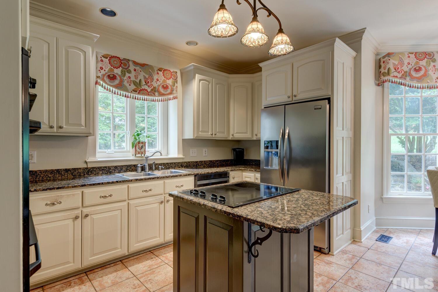 2021 Rolling Rock Road Wake Forest, NC 27587 - Photo 14 of 27 a kitchen with stainless steel appliances granite countertop a stove refrigerator and cabinets
