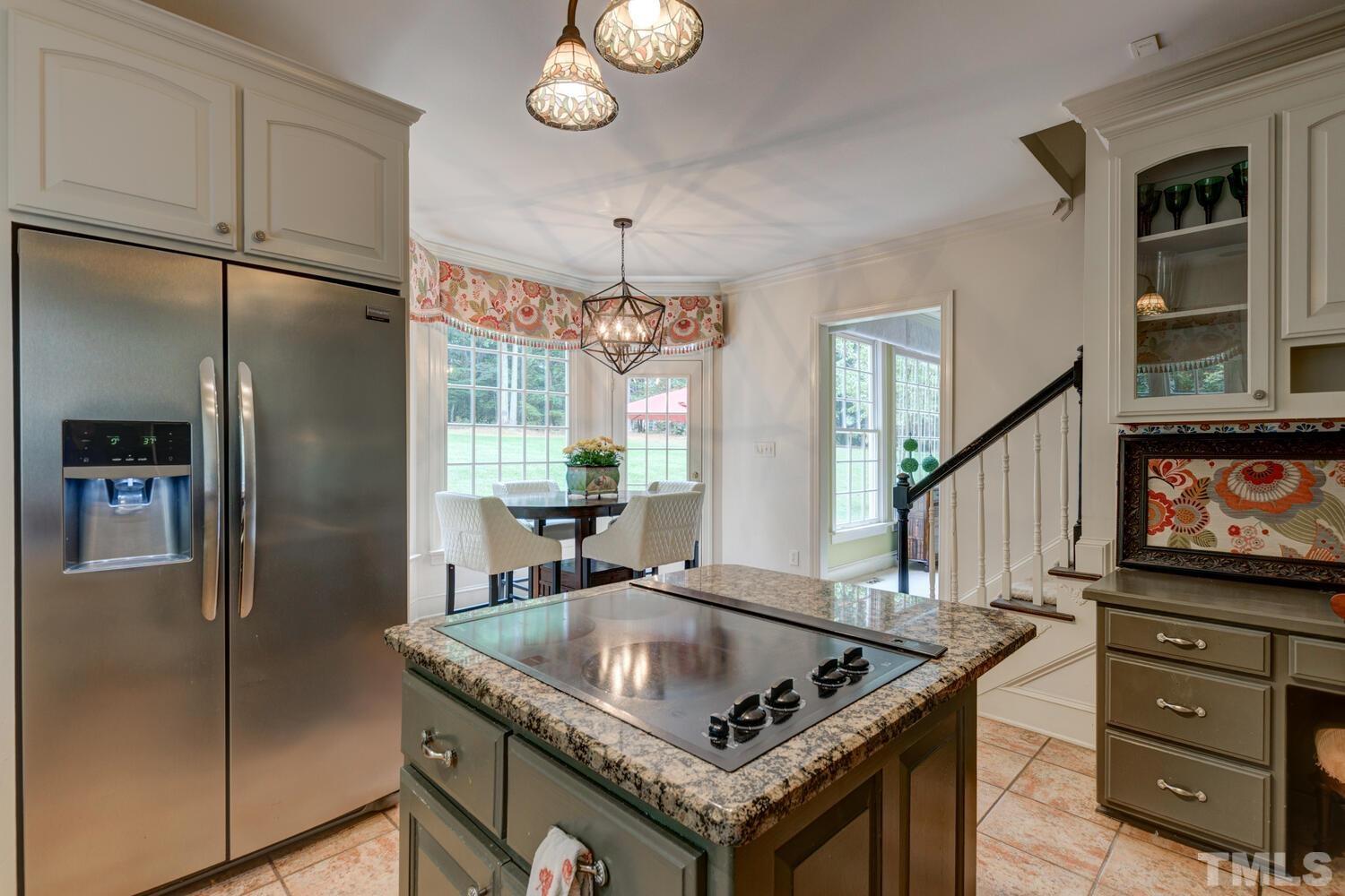 2021 Rolling Rock Road Wake Forest, NC 27587 - Photo 15 of 27 a kitchen with granite countertop a refrigerator a oven a stove and a refrigerator