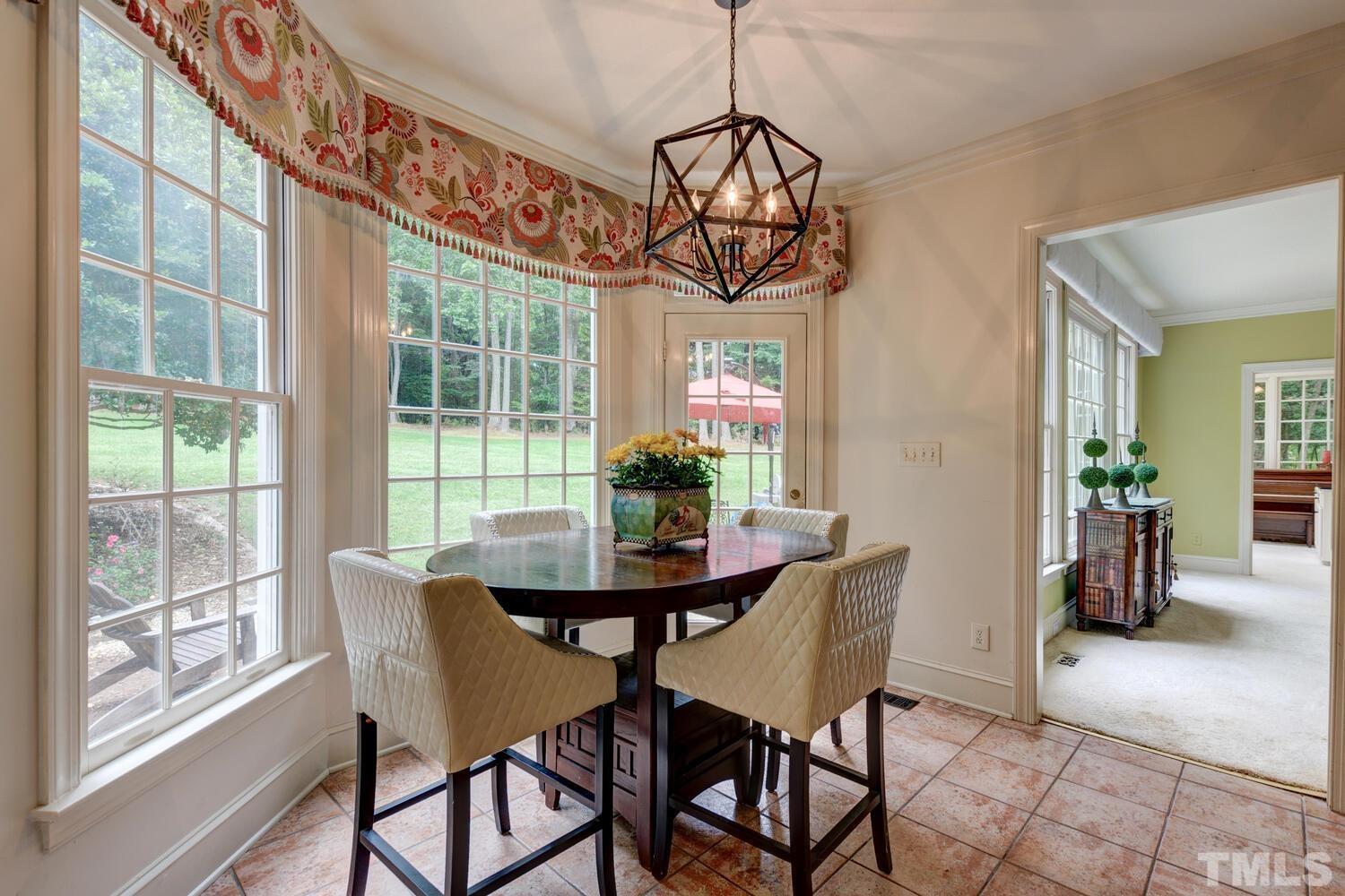2021 Rolling Rock Road Wake Forest, NC 27587 - Photo 17 of 27 a view of a dining room with furniture window and outside view