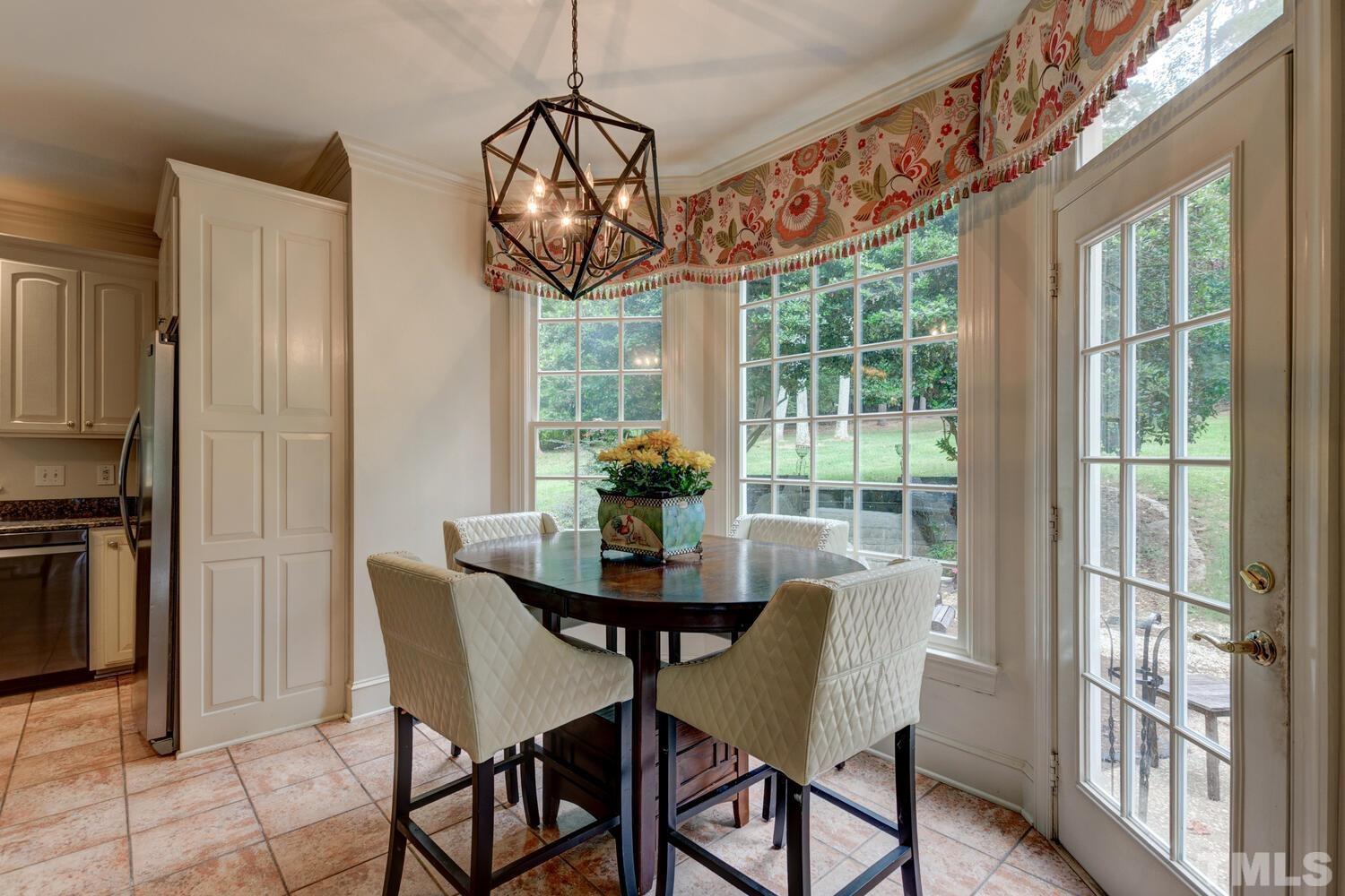 2021 Rolling Rock Road Wake Forest, NC 27587 - Photo 18 of 27 a dining room with furniture a chandelier and window