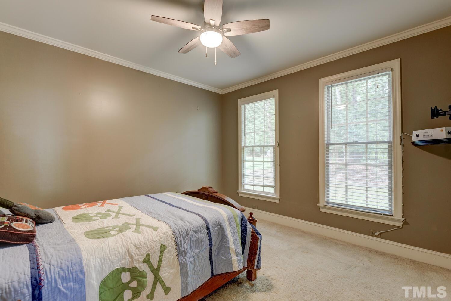 2021 Rolling Rock Road Wake Forest, NC 27587 - Photo 19 of 27 a bedroom with a bed and a window