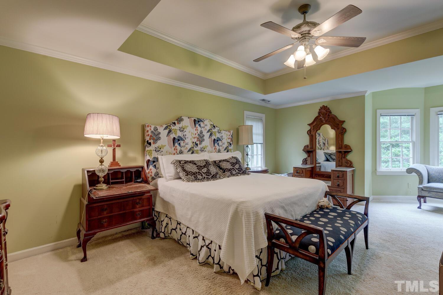 2021 Rolling Rock Road Wake Forest, NC 27587 - Photo 20 of 27 a bedroom with a bed and a chandelier