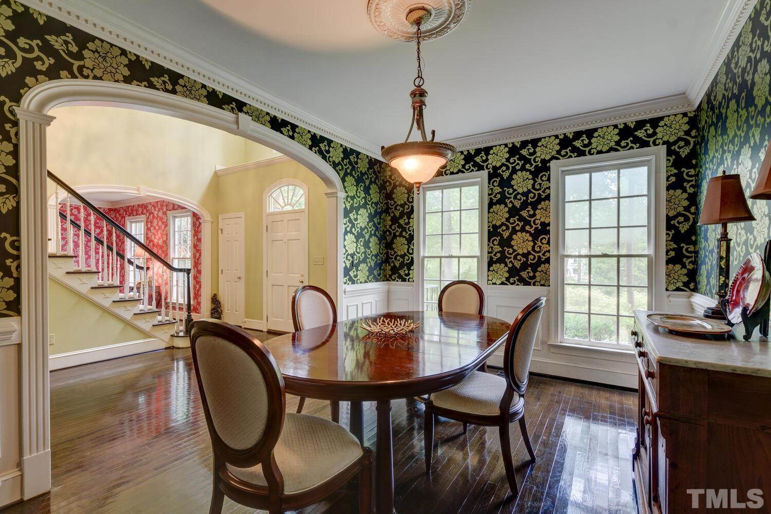 2021 Rolling Rock Road Wake Forest, NC 27587 - Photo 7 of 27 a view of a dining room with furniture and wooden floor