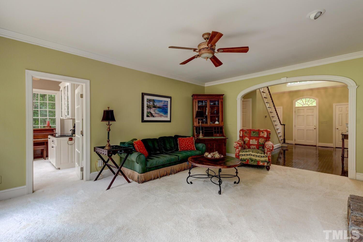 2021 Rolling Rock Road Wake Forest, NC 27587 - Photo 10 of 27 a living room with furniture and a gym machine next to a window