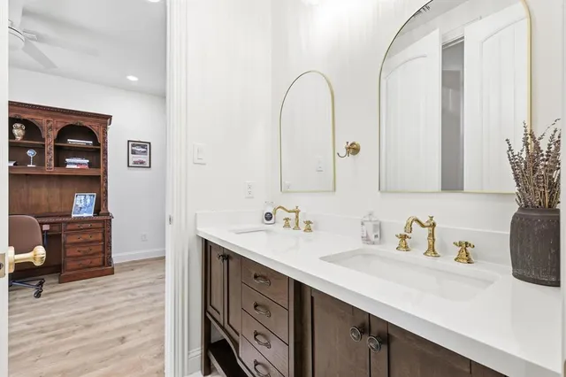 a view of workspace with wooden floor windows cabinet and rug