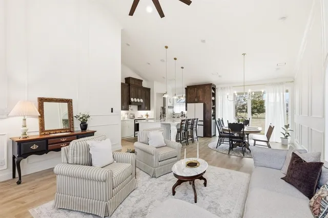 a living room with furniture and a chandelier