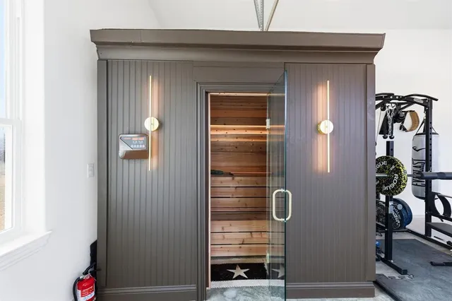 a living room with furniture and a mirror