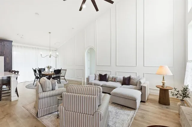 a living room with furniture a fireplace and a large window