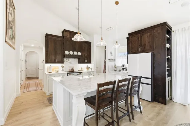 a kitchen with stainless steel appliances kitchen island granite countertop a sink and cabinets