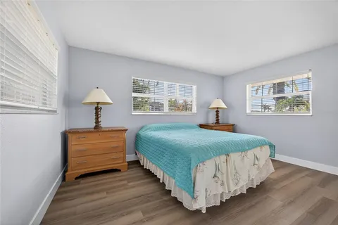 a bedroom with a bed and a lamp on dresser