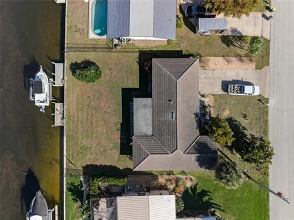 an aerial view of a house with yard