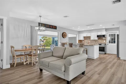 a living room with furniture and kitchen view