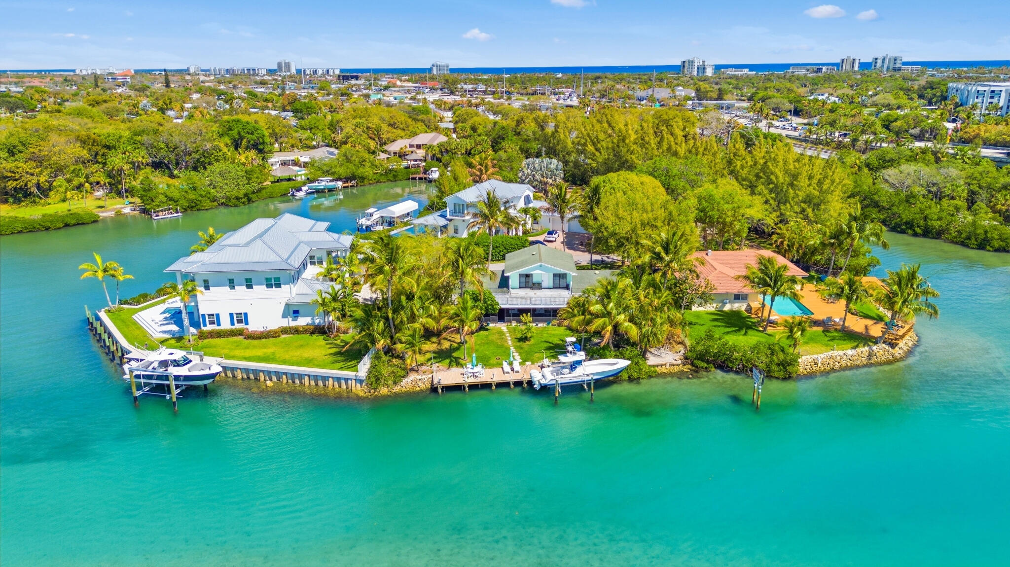1305 Peninsular Road Jupiter, FL 33469 - Photo 1 of 23 an aerial view of a house with a swimming pool a yard and lake view