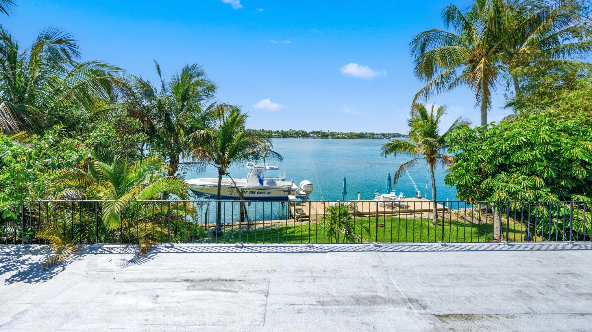 1305 Peninsular Road Jupiter, FL 33469 - Photo 11 of 23 a palm tree sitting in front of a house with a yard