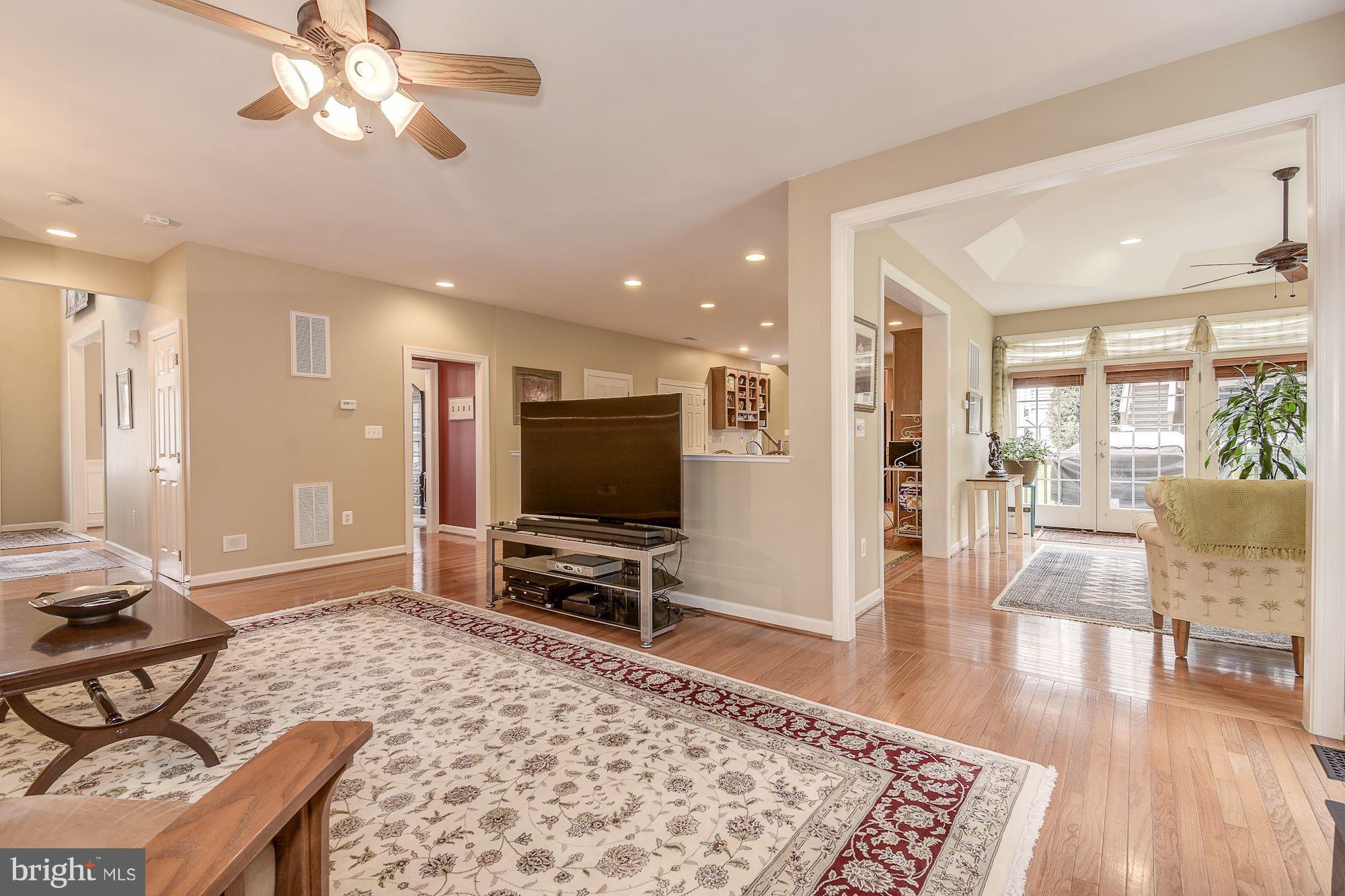 8639 Hillside Manor Drive Springfield, VA 22152 - Photo 13 of 30 a living room with furniture and a flat screen tv