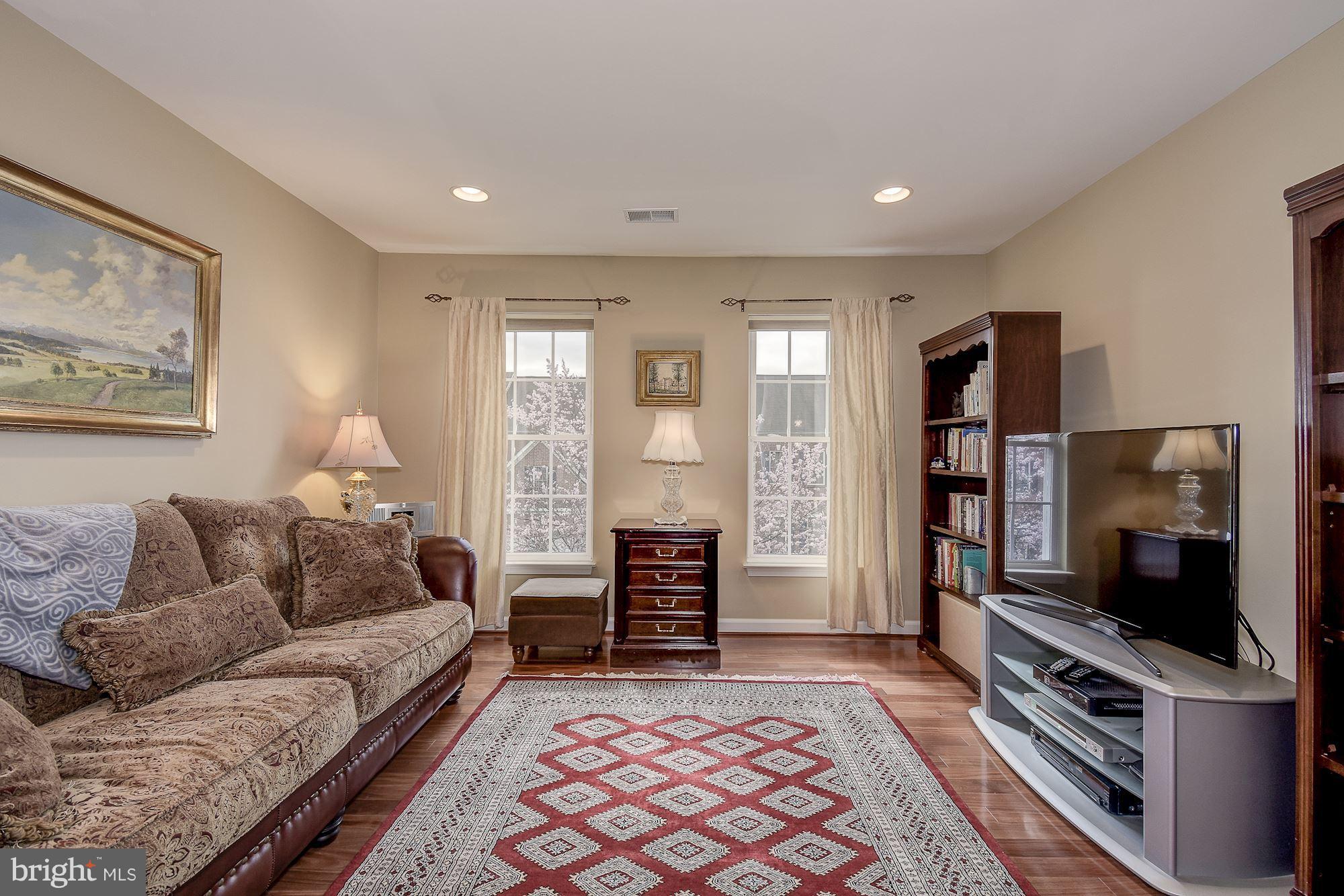 8639 Hillside Manor Drive Springfield, VA 22152 - Photo 17 of 30 a living room with furniture and a flat screen tv