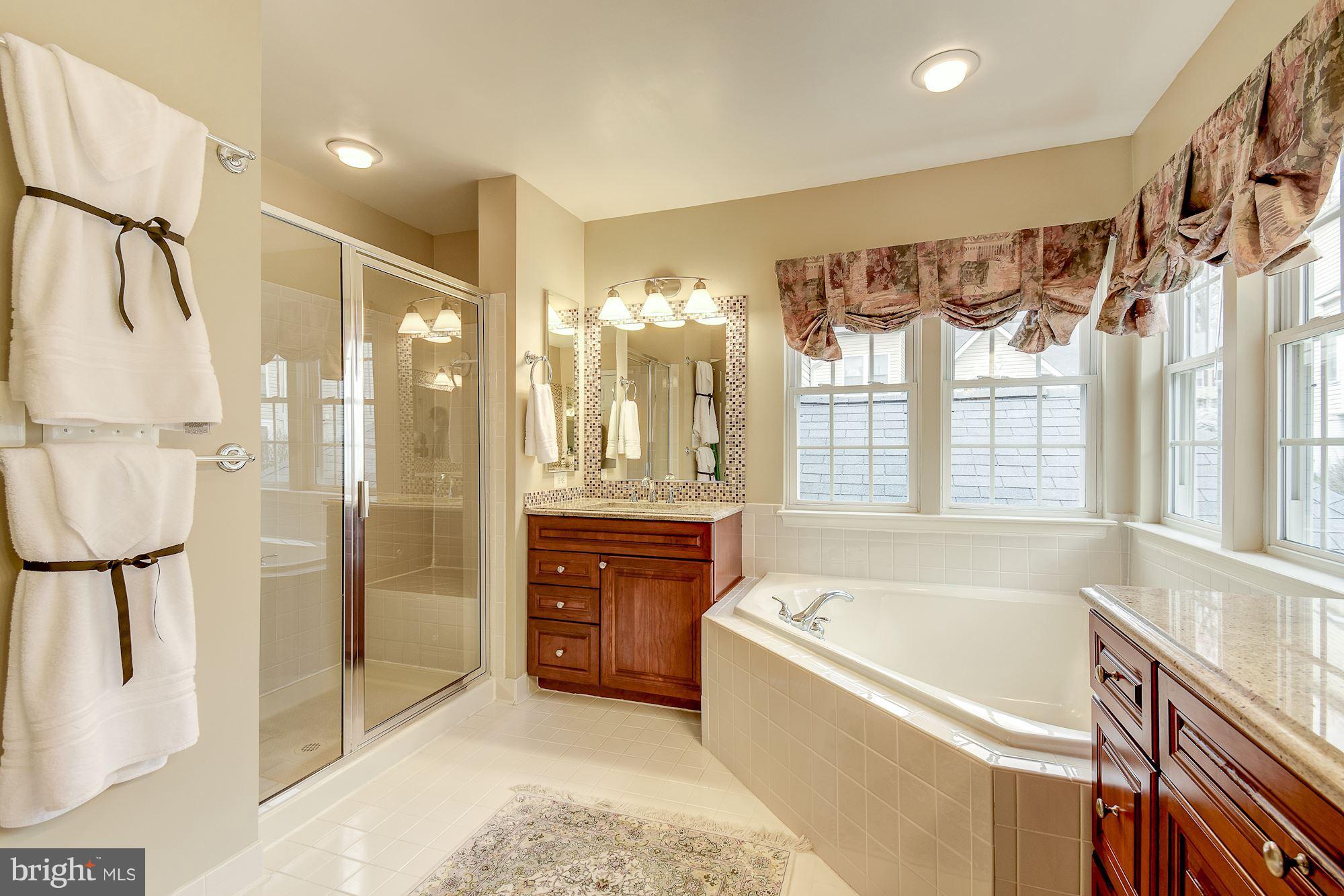 8639 Hillside Manor Drive Springfield, VA 22152 - Photo 18 of 30 a bathroom with a bathtub and a shower