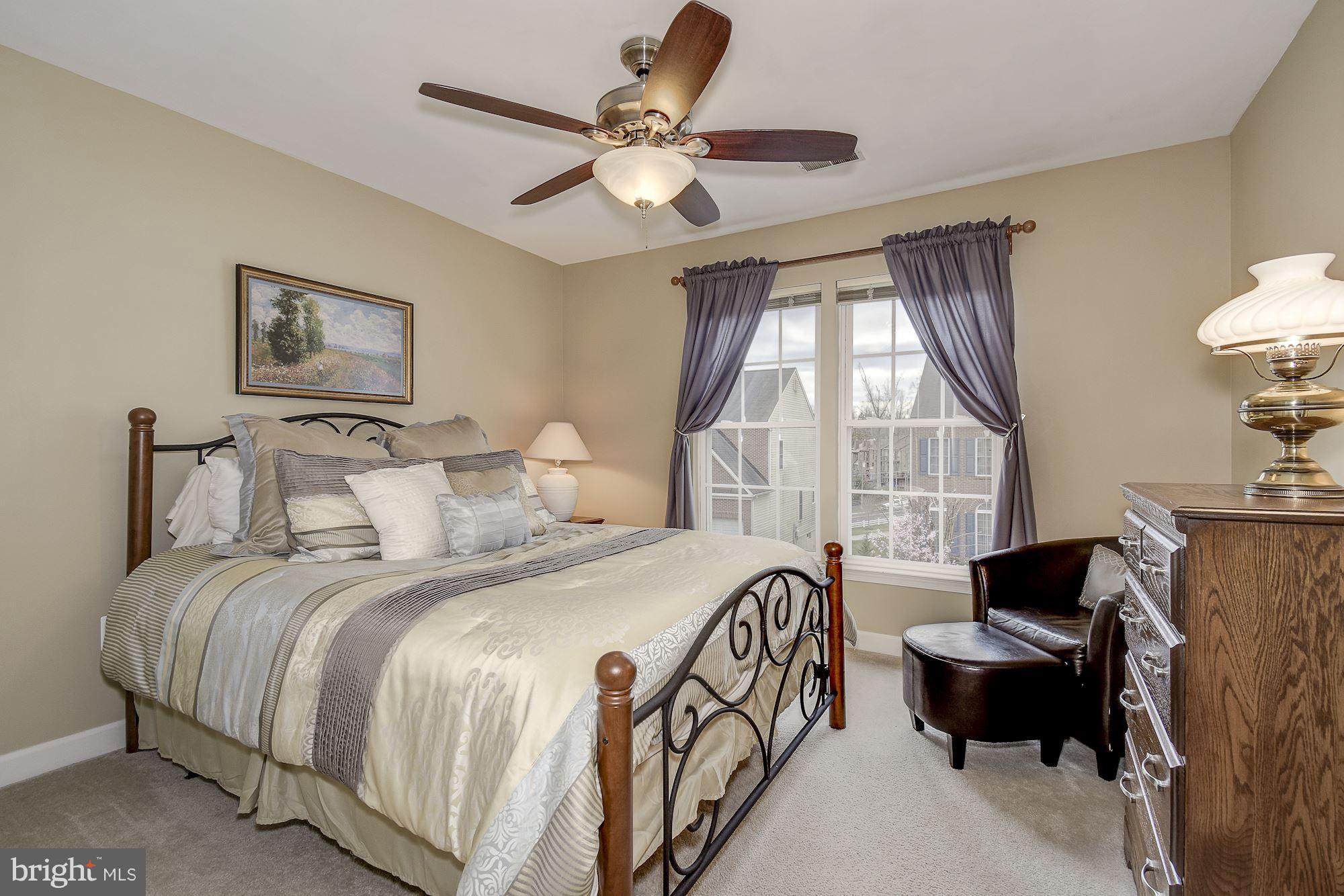 8639 Hillside Manor Drive Springfield, VA 22152 - Photo 20 of 30 a bedroom with a bed couch and window