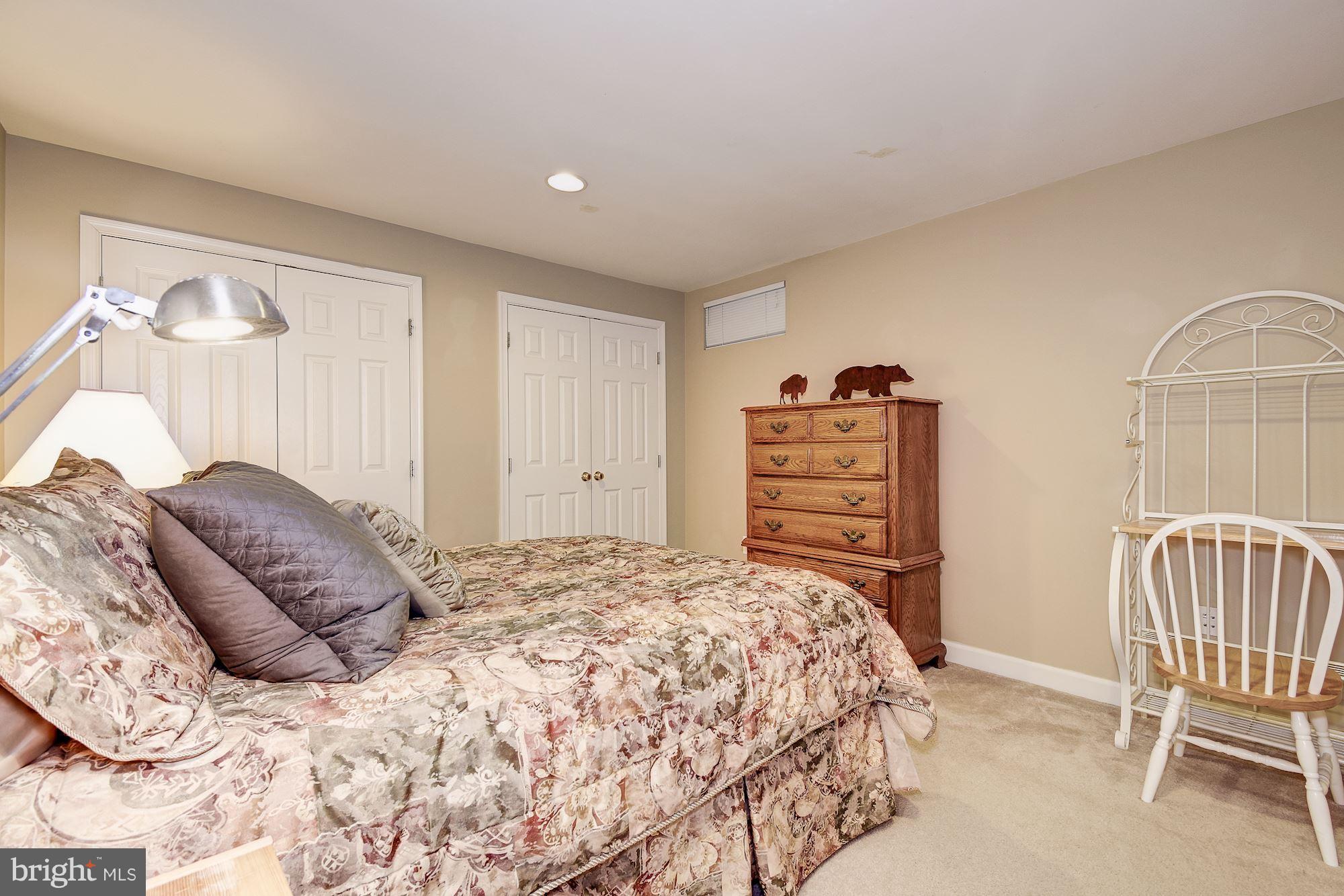8639 Hillside Manor Drive Springfield, VA 22152 - Photo 24 of 30 a bedroom with a bed and a chair