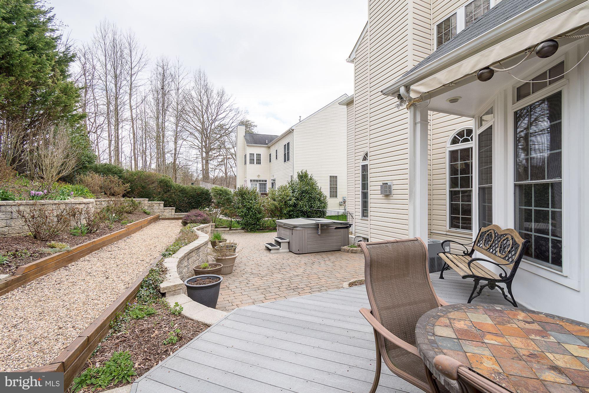 8639 Hillside Manor Drive Springfield, VA 22152 - Photo 26 of 30 a view of a patio with couches table and chairs and potted plants