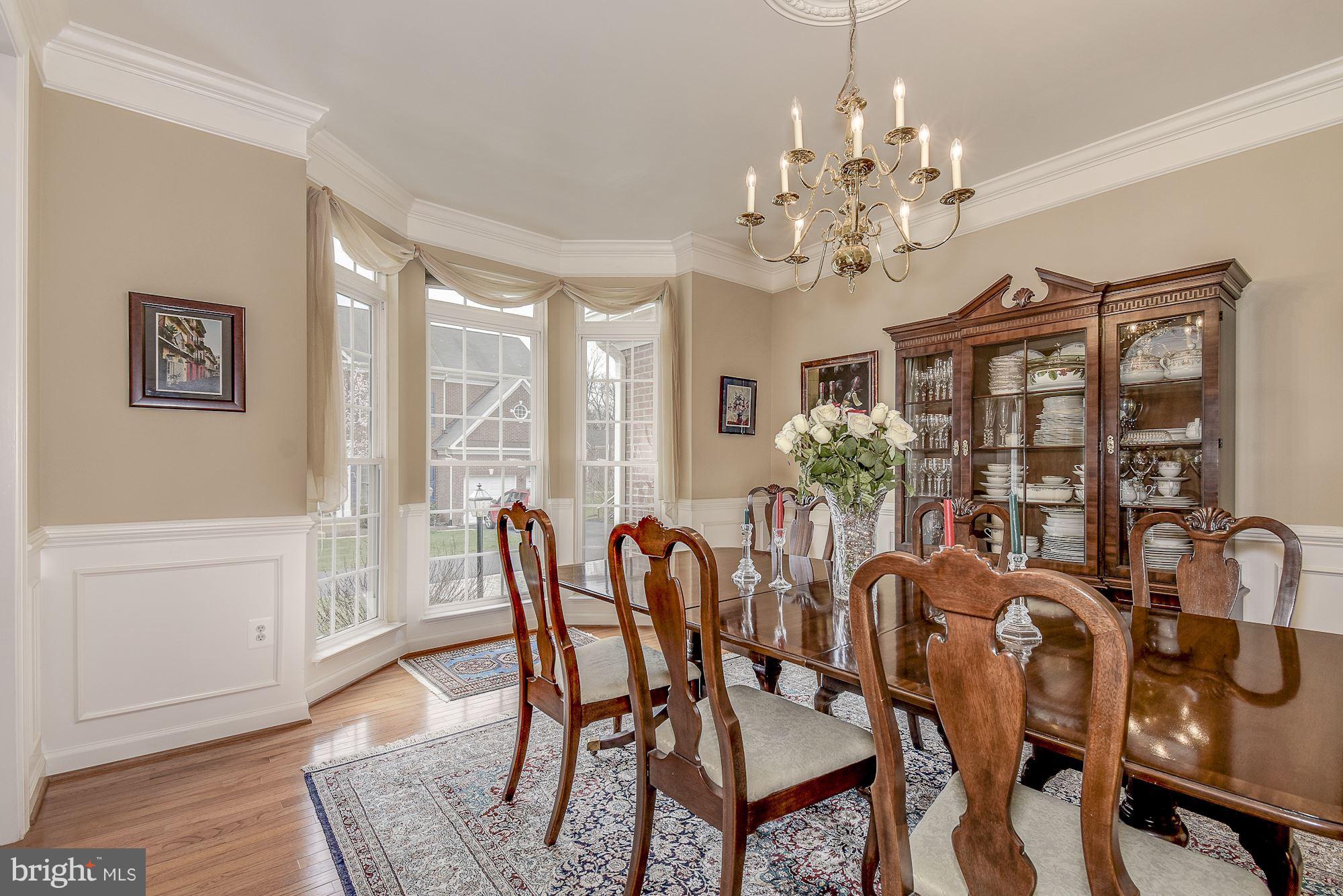 8639 Hillside Manor Drive Springfield, VA 22152 - Photo 10 of 30 a view of a dining room with furniture window and wooden floor