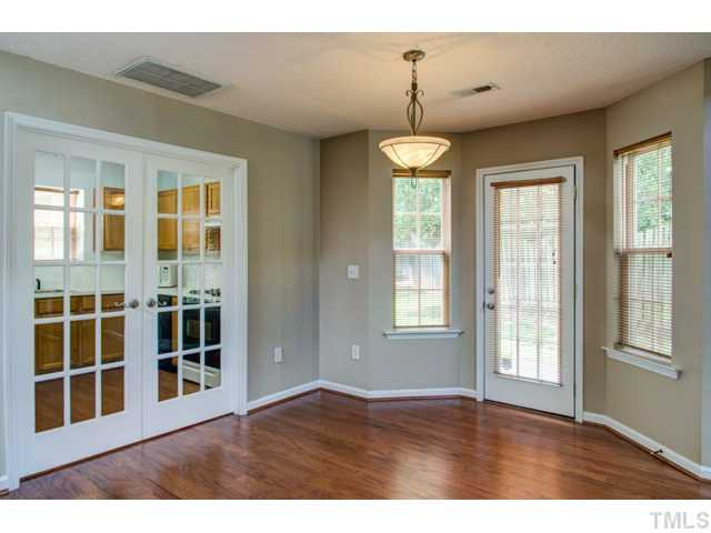 4512 Nightfall Court Durham, NC 27713 - Photo 12 of 24 a view of an empty room with a window and wooden floor