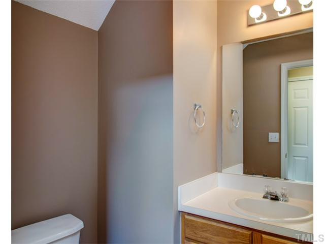 4512 Nightfall Court Durham, NC 27713 - Photo 13 of 24 a bathroom with a sink and a mirror