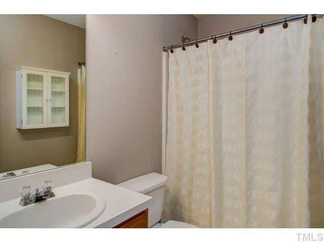 4512 Nightfall Court Durham, NC 27713 - Photo 15 of 24 a bathroom with a sink and a mirror