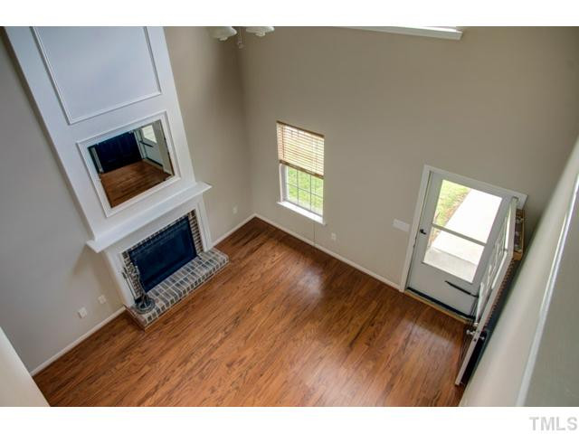 4512 Nightfall Court Durham, NC 27713 - Photo 17 of 24 a view of an empty room with wooden floor and a window