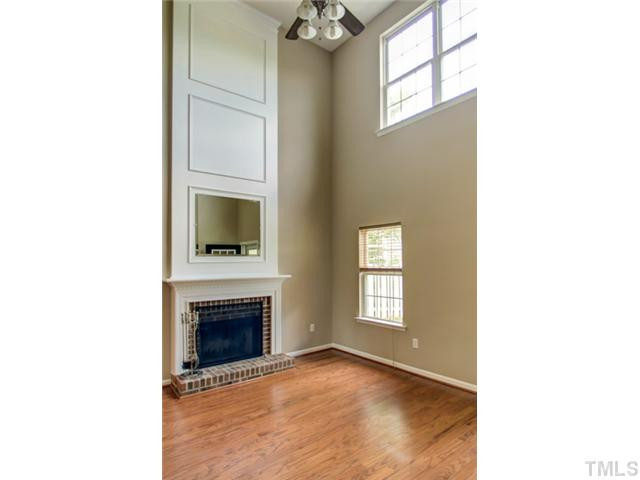 4512 Nightfall Court Durham, NC 27713 - Photo 5 of 24 a view of an empty room with a fireplace and a window