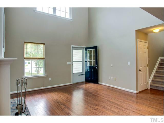 4512 Nightfall Court Durham, NC 27713 - Photo 6 of 24 a view of an empty room with wooden floor and a window