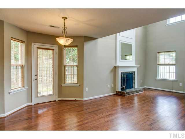 4512 Nightfall Court Durham, NC 27713 - Photo 8 of 24 a view of an empty room with wooden floor and a window