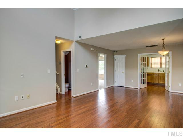 4512 Nightfall Court Durham, NC 27713 - Photo 9 of 24 a view of an empty room with wooden floor and a window