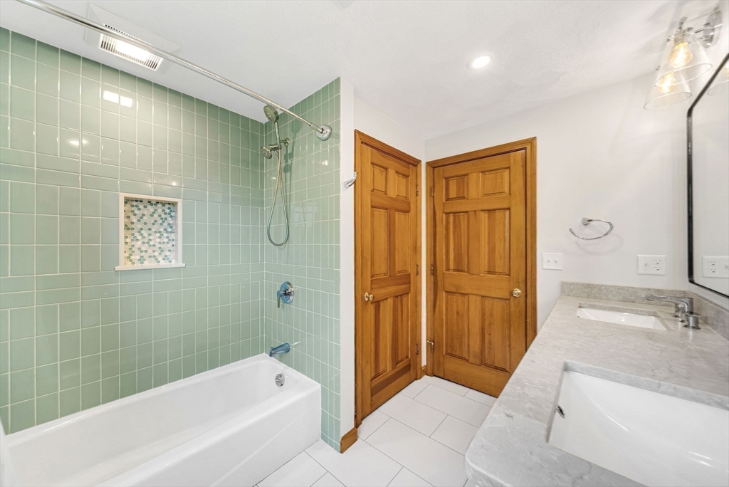 83 Jefferson Road Franklin, MA 02038 - Photo 20 of 34 a bathroom with a granite countertop sink a mirror bathtub and shower