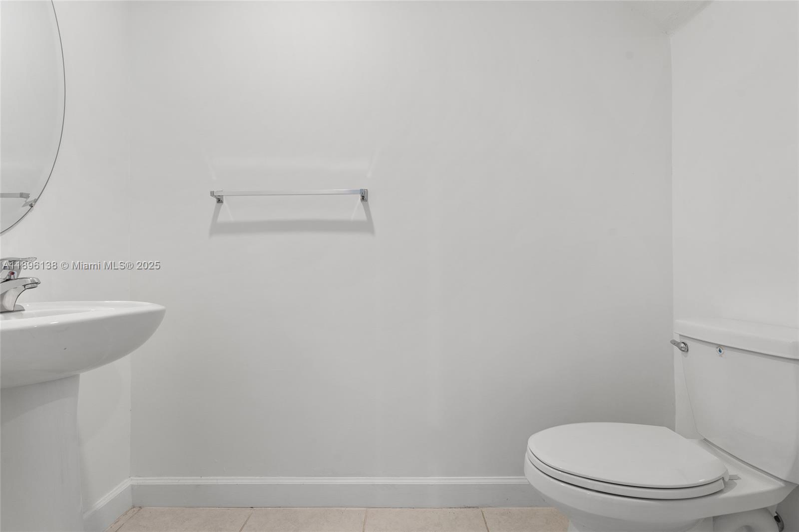 2405 Northwest 131st Street Miami, FL 33167 - Photo 11 of 38 a bathroom with a sink a toilet and vanity