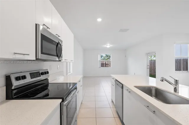 a kitchen with stainless steel appliances granite countertop a sink and stove top oven