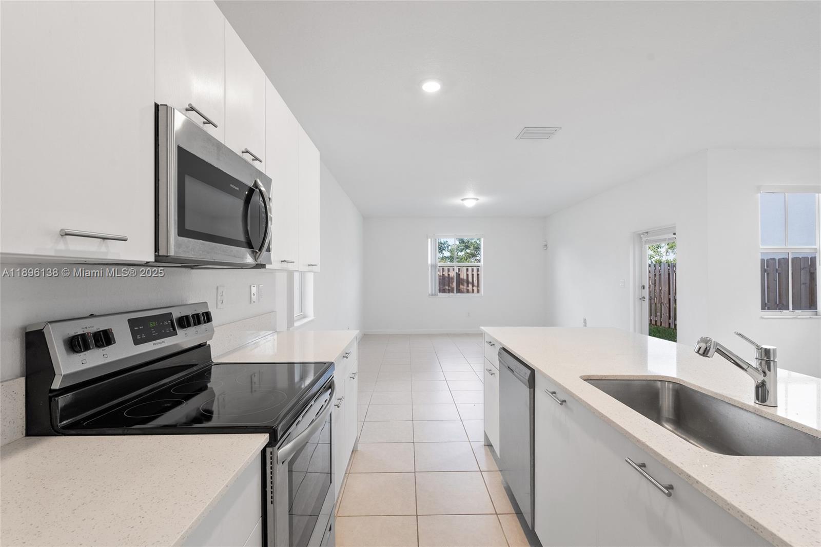 2405 Northwest 131st Street Miami, FL 33167 - Photo 15 of 38 a kitchen with stainless steel appliances granite countertop a sink and stove top oven
