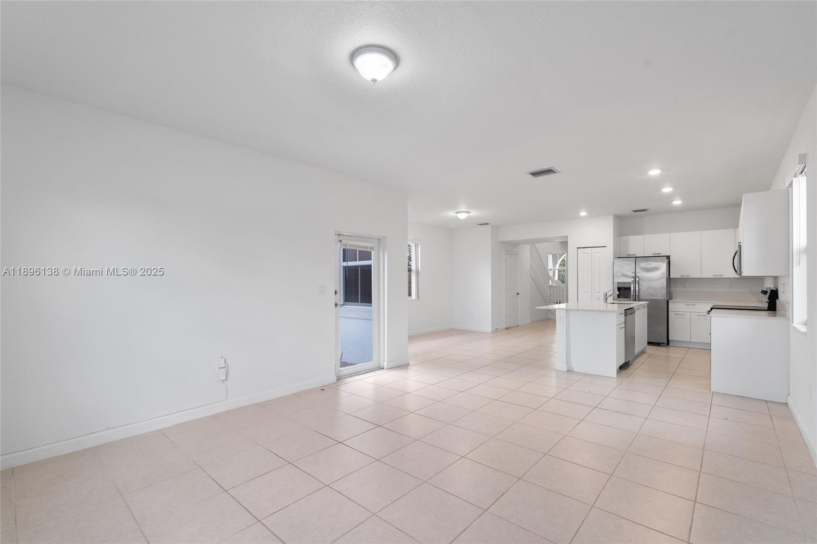 2405 Northwest 131st Street Miami, FL 33167 - Photo 19 of 38 a view of a kitchen with furniture and a refrigerator