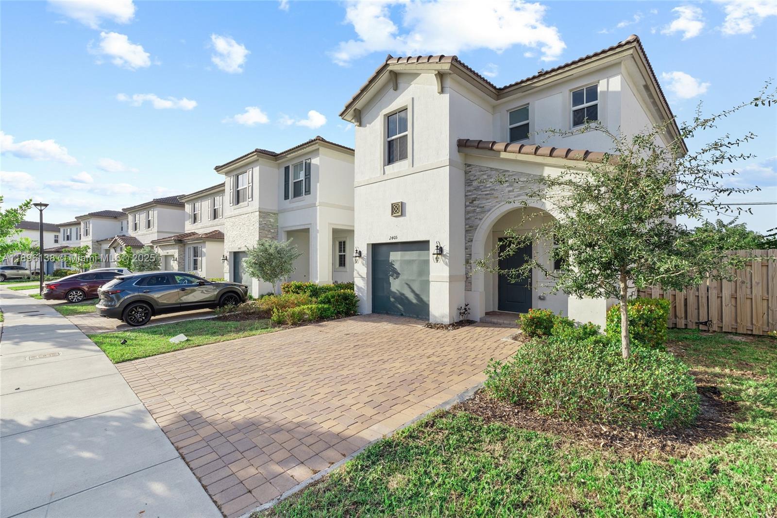 2405 Northwest 131st Street Miami, FL 33167 - Photo 3 of 38 a front view of a house with a garden and mountain view