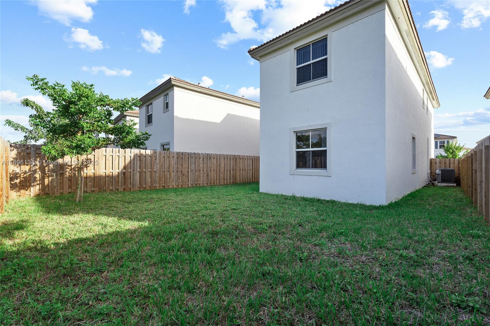 2405 Northwest 131st Street Miami, FL 33167 - Photo 34 of 38 a view of backyard with potted plants and wooden fence
