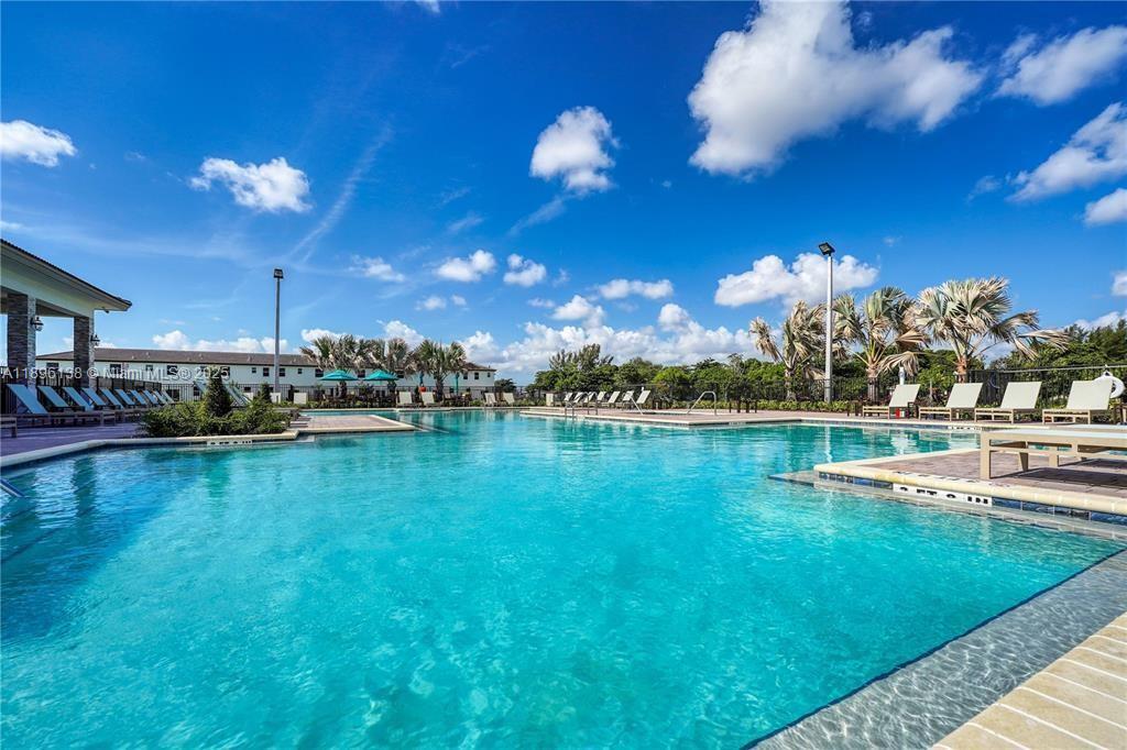 2405 Northwest 131st Street Miami, FL 33167 - Photo 36 of 38 a view of a swimming pool with a table and chairs