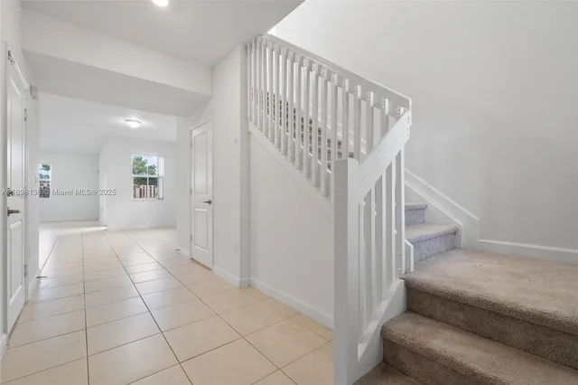 a view of entryway and hall with a couch