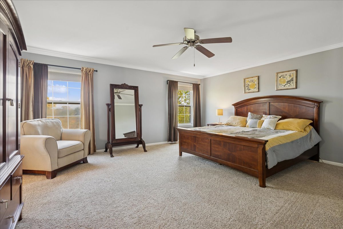 2681 Braeburn Way Woodstock, IL 60098 - Photo 16 of 41 a spacious bedroom with a bed and a couch