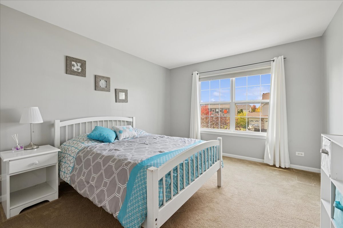 2681 Braeburn Way Woodstock, IL 60098 - Photo 19 of 41 a bedroom with a bed and a window