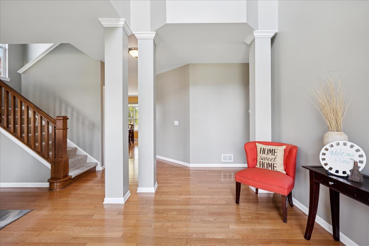2681 Braeburn Way Woodstock, IL 60098 - Photo 6 of 41 a living room with furniture and a wooden floor