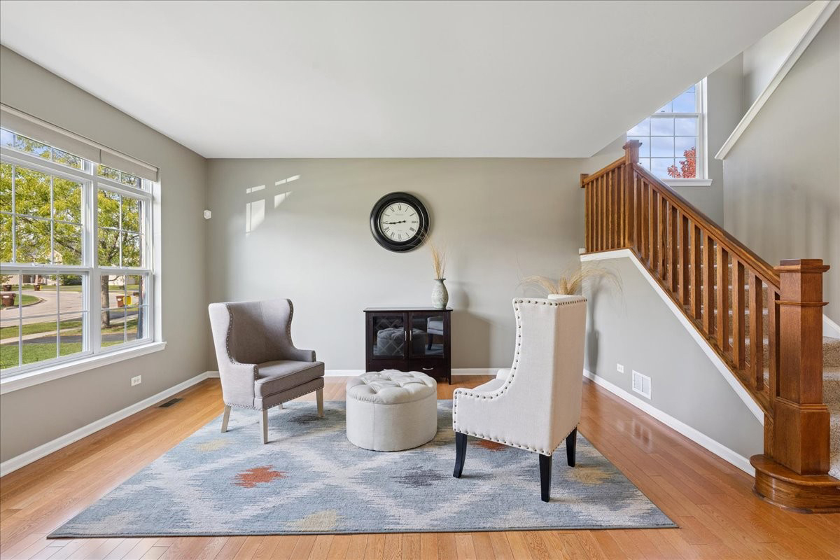 2681 Braeburn Way Woodstock, IL 60098 - Photo 7 of 41 a view of a livingroom with furniture wooden floor and window
