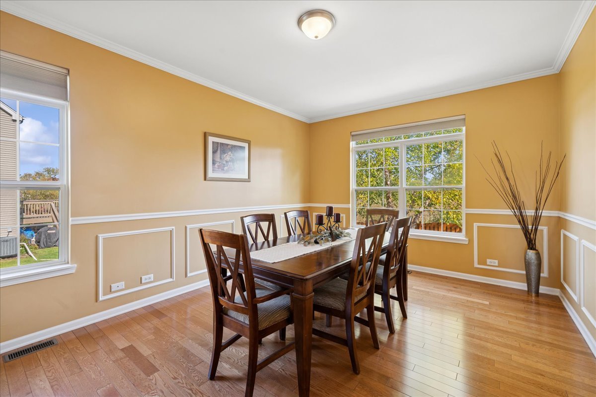 2681 Braeburn Way Woodstock, IL 60098 - Photo 8 of 41 a view of a dining room with furniture and wooden floor