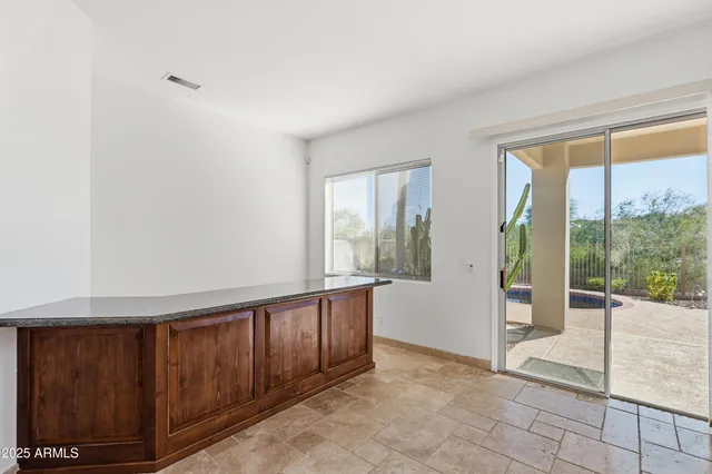 a view of an entryway with wooden floor and door