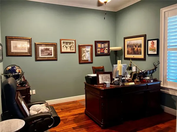 a view of a dining room with furniture a chandelier and wooden floor