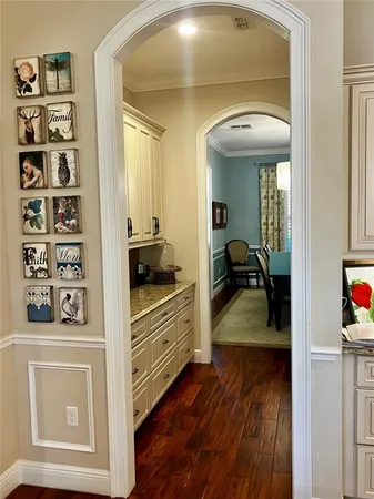 a kitchen with stainless steel appliances a table chairs and a refrigerator
